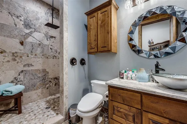 a bathroom with a toilet sink and mirror