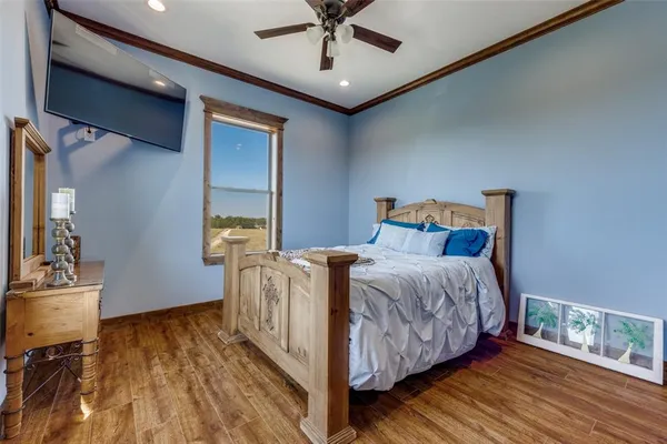 a bedroom with bed and wooden floor