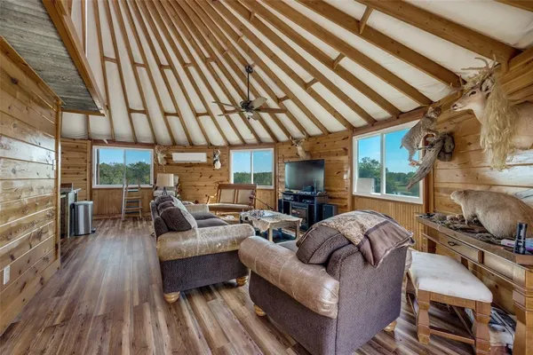 a living room with furniture a fireplace and wooden floor