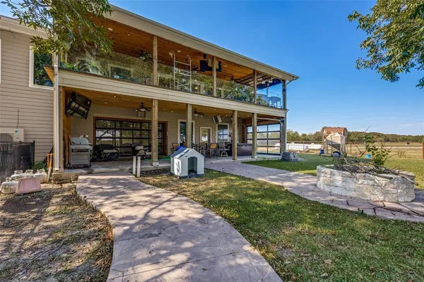 a view of a house with backyard porch and sitting area