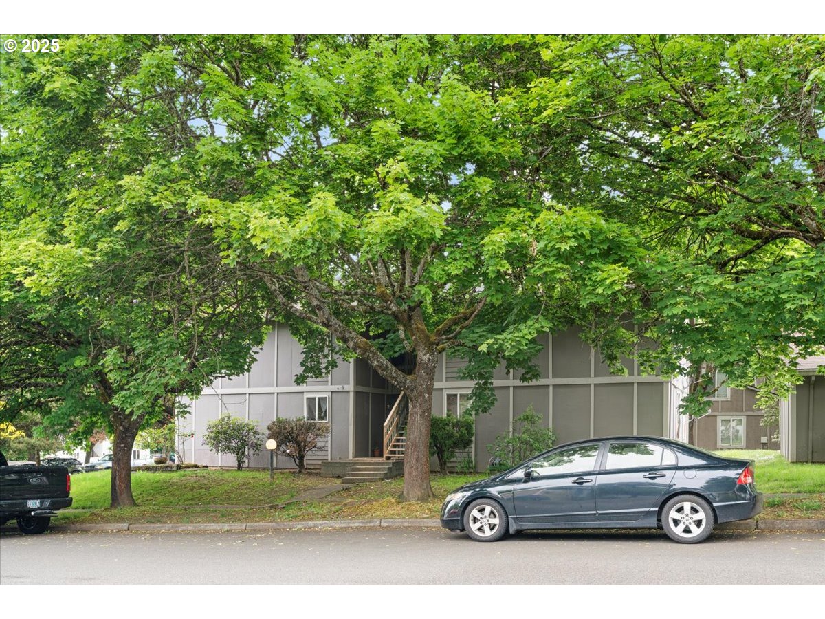 9750 Southwest Lookout Terrace Beaverton, OR 97008 - Photo 8 of 14 a car parked in front of a house with a parked car