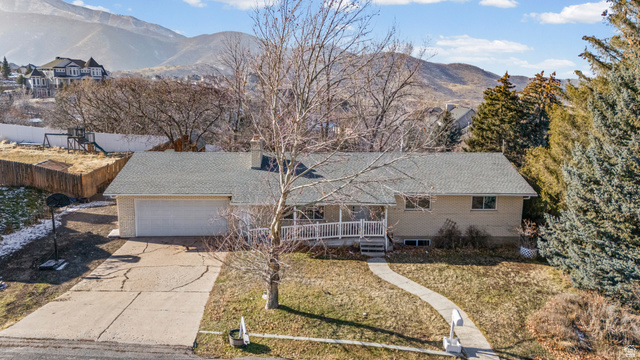 44 South Astor Lane Elk Ridge, UT 84651 - Photo 1 of 1 Single story home with brick siding, driveway, a deck with mountain view, and an attached garage