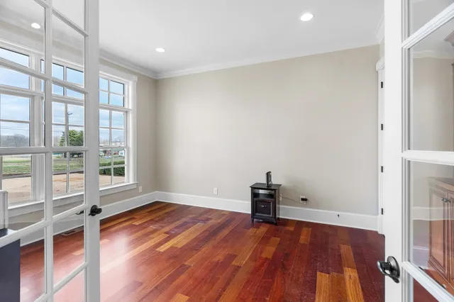 a kitchen with kitchen island granite countertop wooden cabinets a dining table and chairs