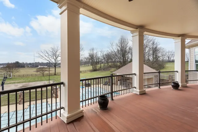 a room with stainless steel appliances lots of wooden furniture