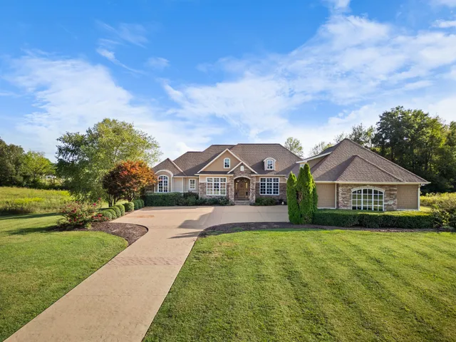 a kitchen with stainless steel appliances a dining table chairs and wooden floor