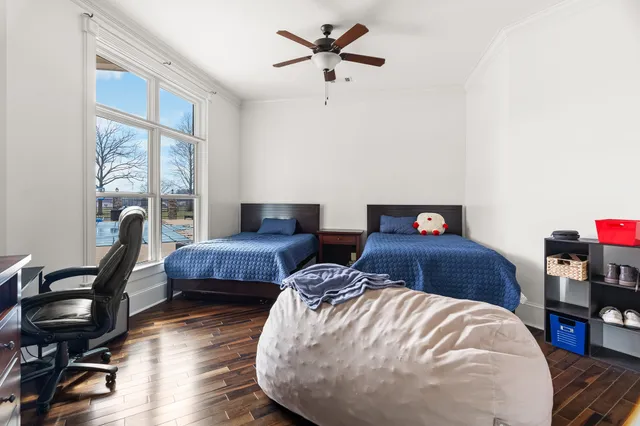 a view of a big house with a big yard and potted plants in front of the house