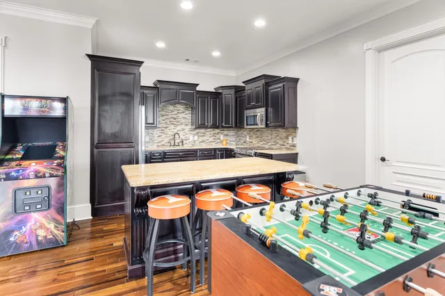 a view of a big house with a big yard and large trees