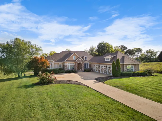 a dining room with furniture a chandelier and wooden floor