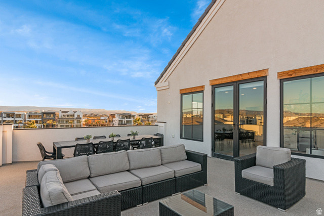 5367 Cyan Lane St. George, UT 84790 - Photo 34 of 49 Rooftop patio with smooth stucco exterior, dark-framed windows, and a glass-paneled door