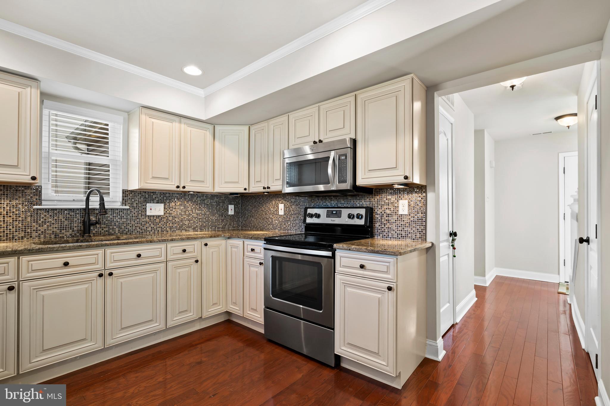 17 Alberts Way Langhorne, PA 19047 - Photo 11 of 35 a kitchen with stainless steel appliances granite countertop a stove a sink and white cabinets