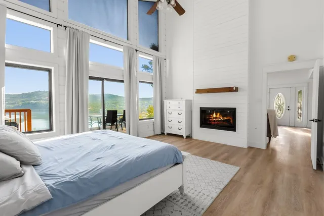 a spacious bedroom with a balcony a bed and a fireplace