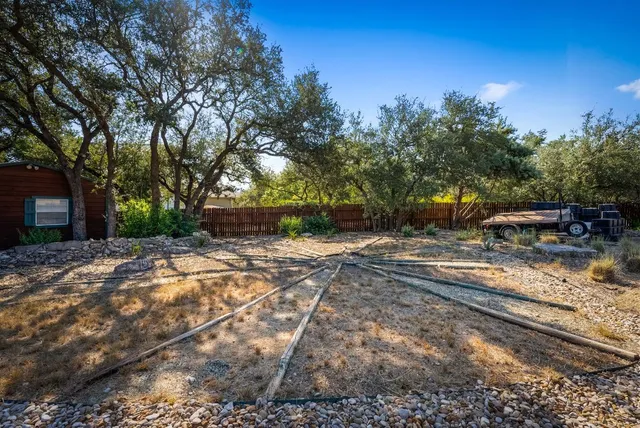 a view of a yard with cars