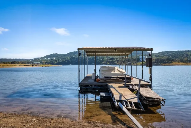 a view of a balcony with wooden floor and outdoor seating