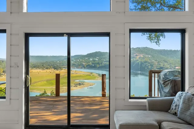 a living room with furniture and a floor to ceiling window