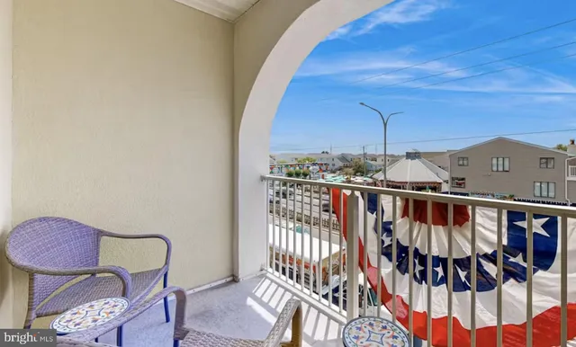 a view of a balcony with chair and wooden floor