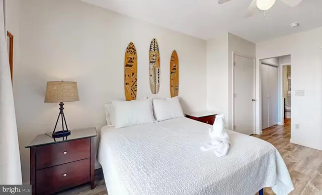 a bedroom with a bed and a night stand