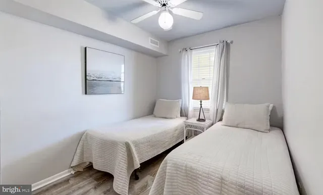 a bedroom with two beds and a chandelier
