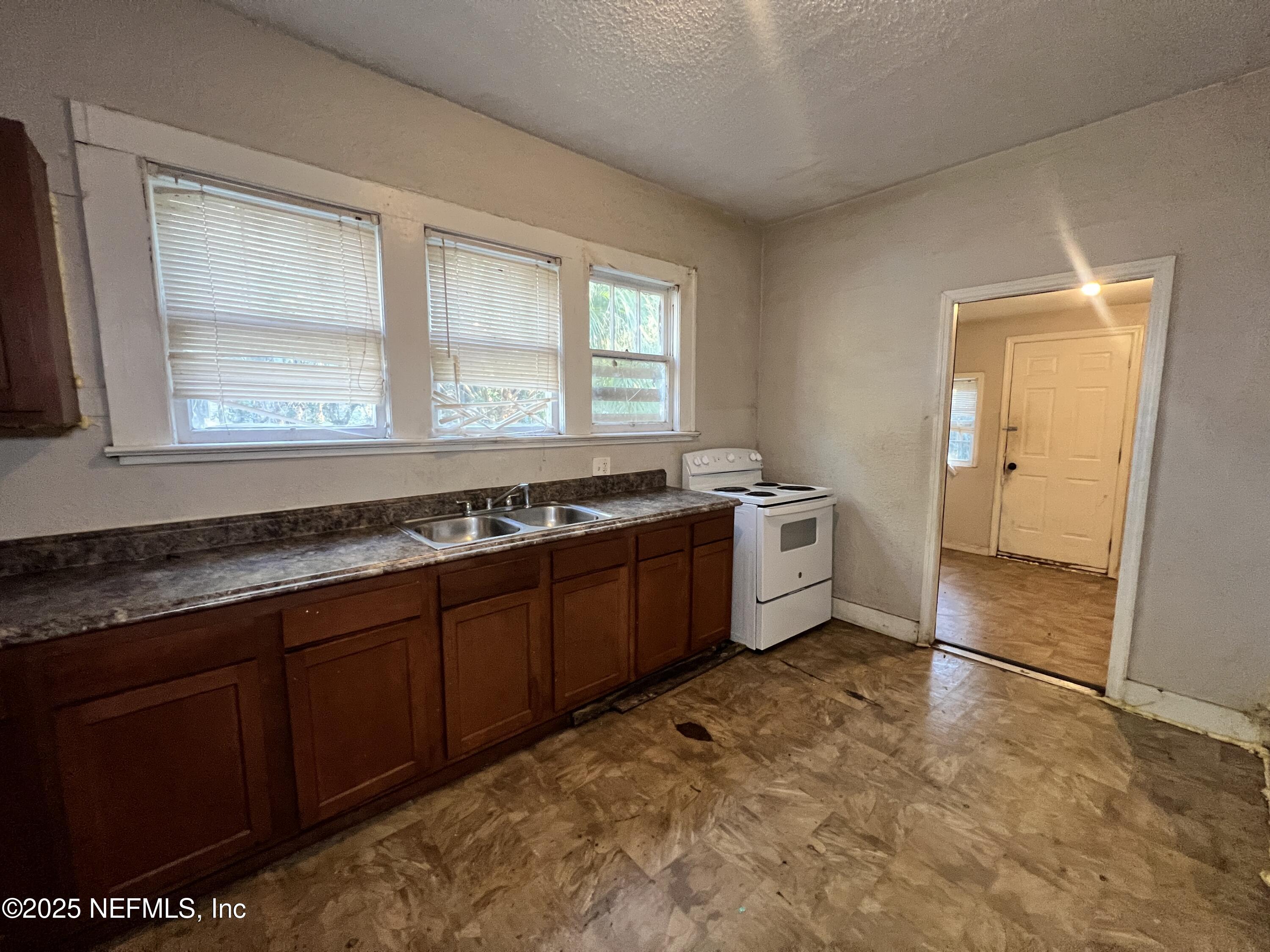 408 West 23rd Street Jacksonville, FL 32206 - Photo 15 of 45 a kitchen with stainless steel appliances a sink a stove and a refrigerator