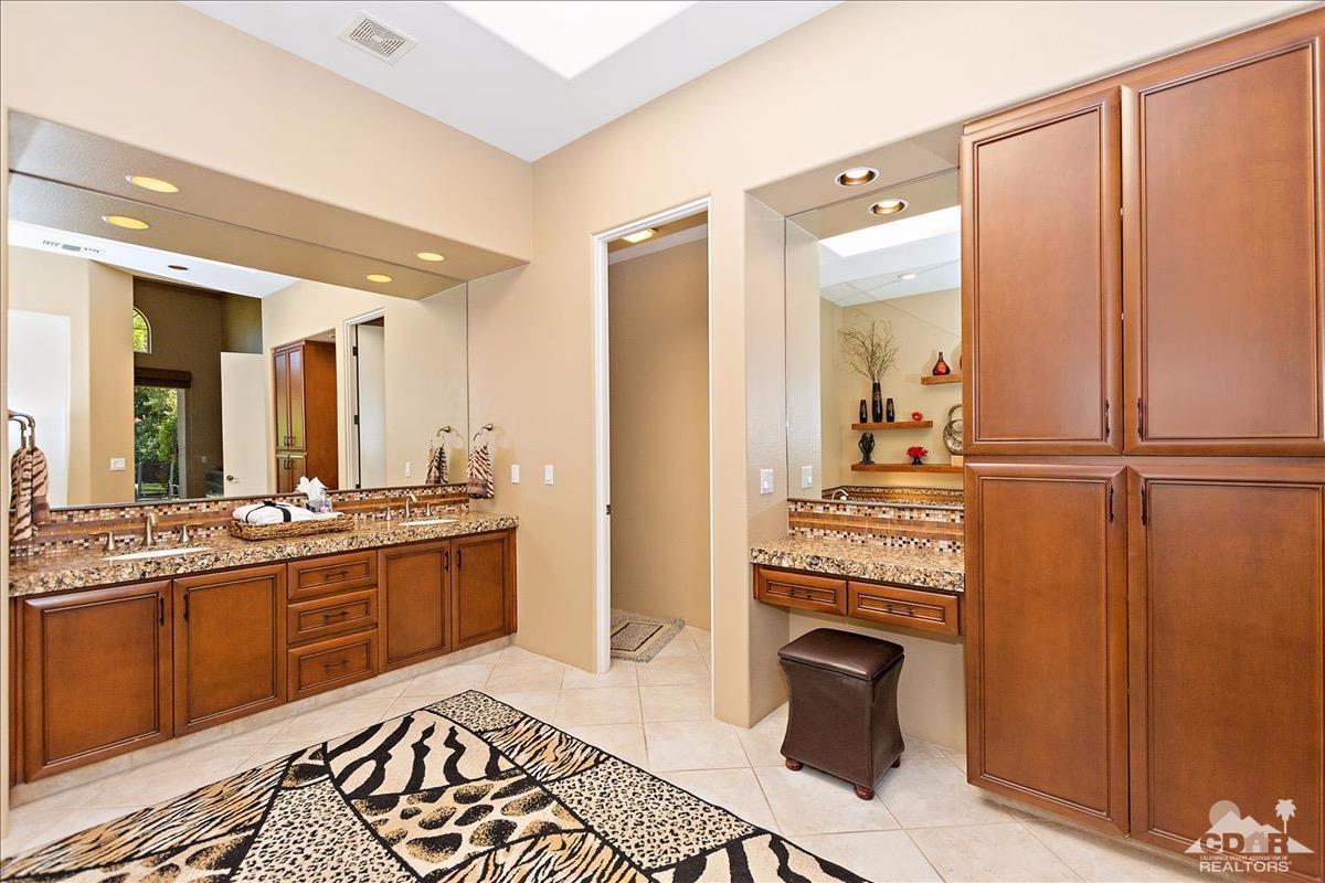 48010 Vía Vallarta La Quinta, CA 92253 - Photo 15 of 37 a large bathroom with a sink a mirror and a shower