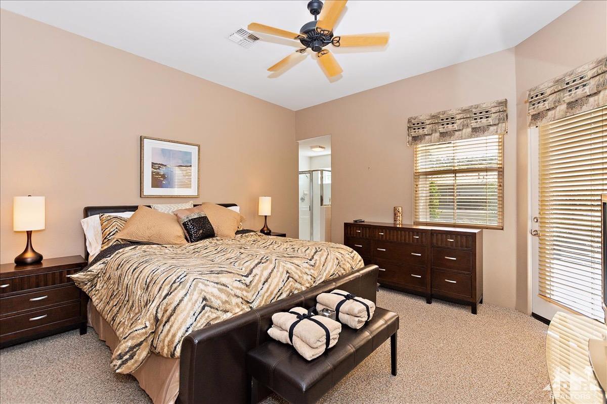 48010 Vía Vallarta La Quinta, CA 92253 - Photo 19 of 37 a bedroom with a bed and window