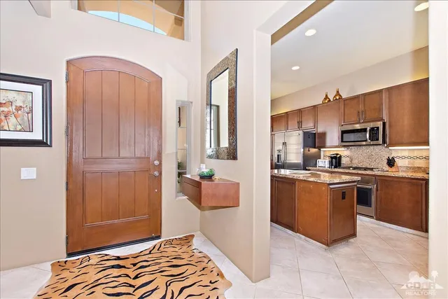 a kitchen with stainless steel appliances granite countertop a refrigerator and a stove top oven