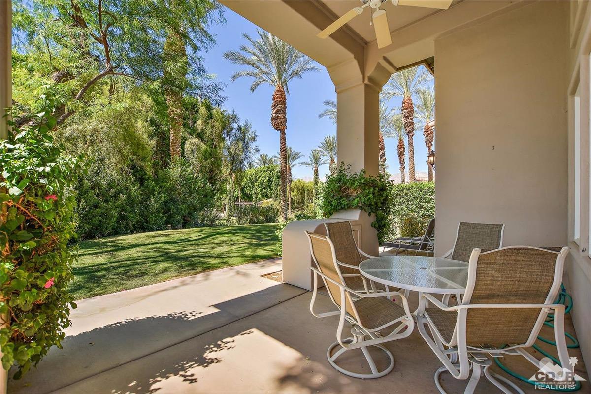 48010 Vía Vallarta La Quinta, CA 92253 - Photo 27 of 37 a view of a patio with table and chairs and potted plants