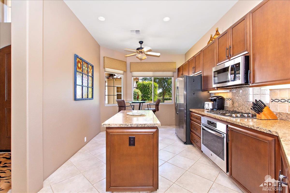 48010 Vía Vallarta La Quinta, CA 92253 - Photo 6 of 37 a kitchen with stainless steel appliances granite countertop a stove and a sink