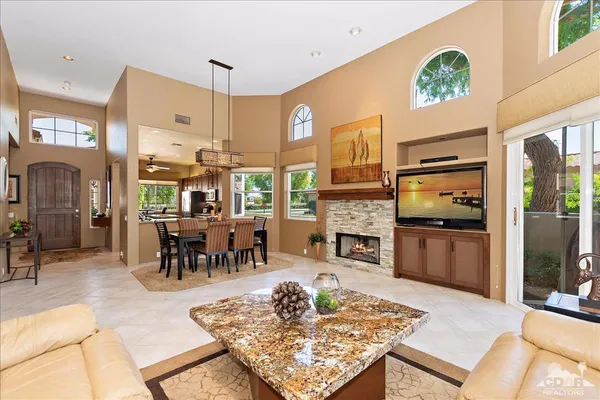 a living room with fireplace furniture and a table