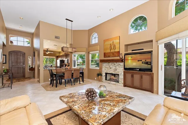 a living room with fireplace furniture and a table