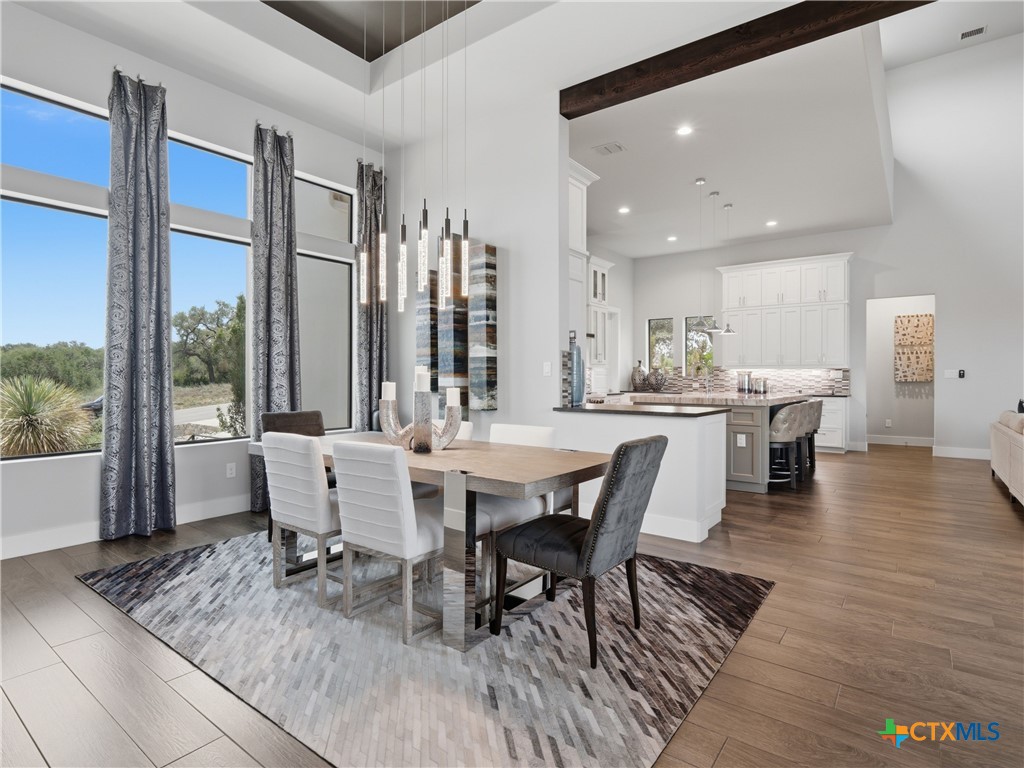 5913 Verden Ridge New Braunfels, TX 78132 - Photo 5 of 48 a view of a dining room with furniture and wooden floor