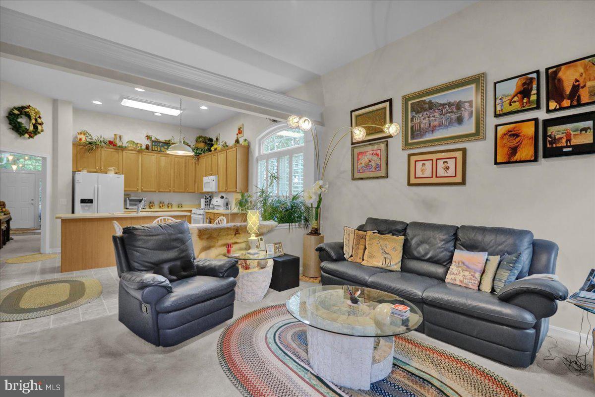 213 Aster Circle Kennett Square, PA 19348 - Photo 19 of 39 a living room with furniture and a view of kitchen