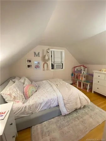a bedroom with a bed and a car