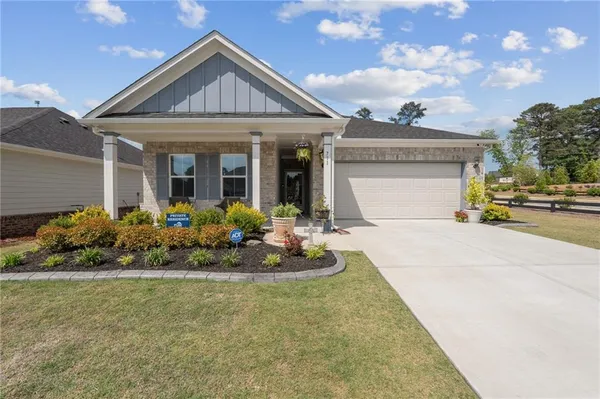 a front view of a house with a garden