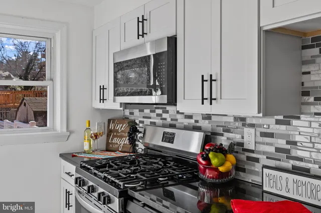 a kitchen with stove and cabinets
