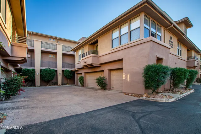 a front view of a house with yard and glass windows