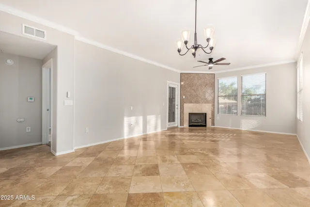 a view of an empty room with a fireplace and a window