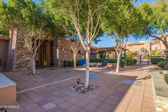 a front view of a house with a tree