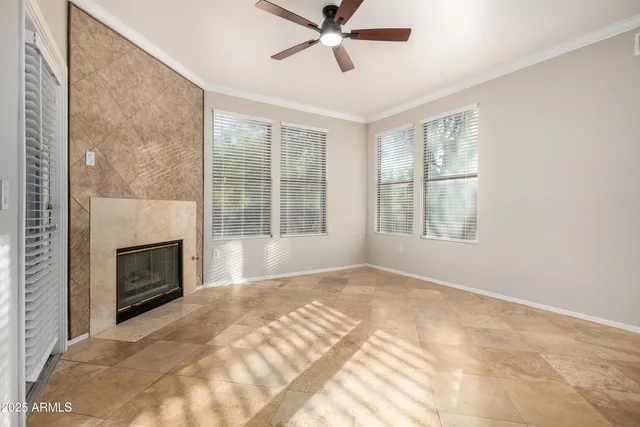 a view of an empty room with a fireplace and a window