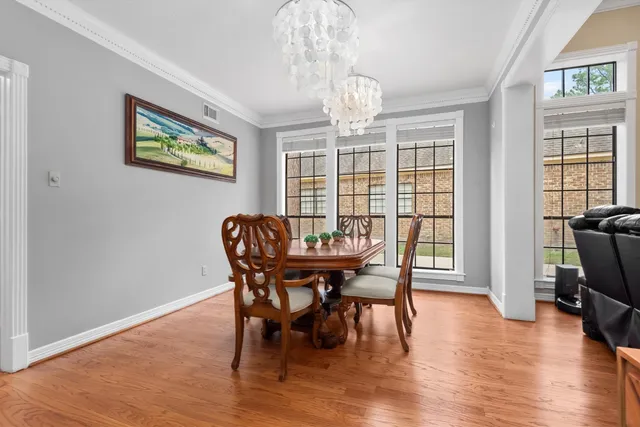 a view of a dining room with furniture wooden floor and chandelier