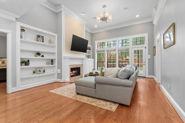 a living room with furniture a fireplace and a flat screen tv