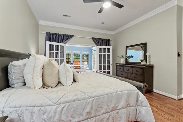 a bedroom with a large bed and a flat tv screen