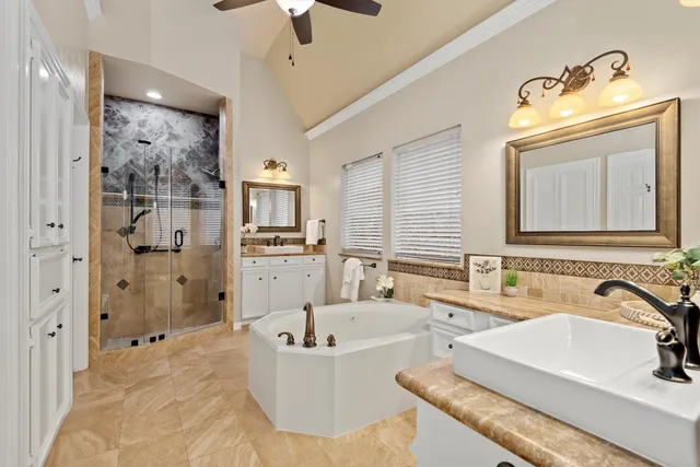a bathroom with a tub sink and mirror