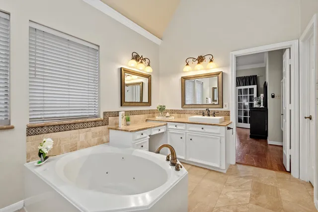 a spacious bathroom with a sink and a bathtub