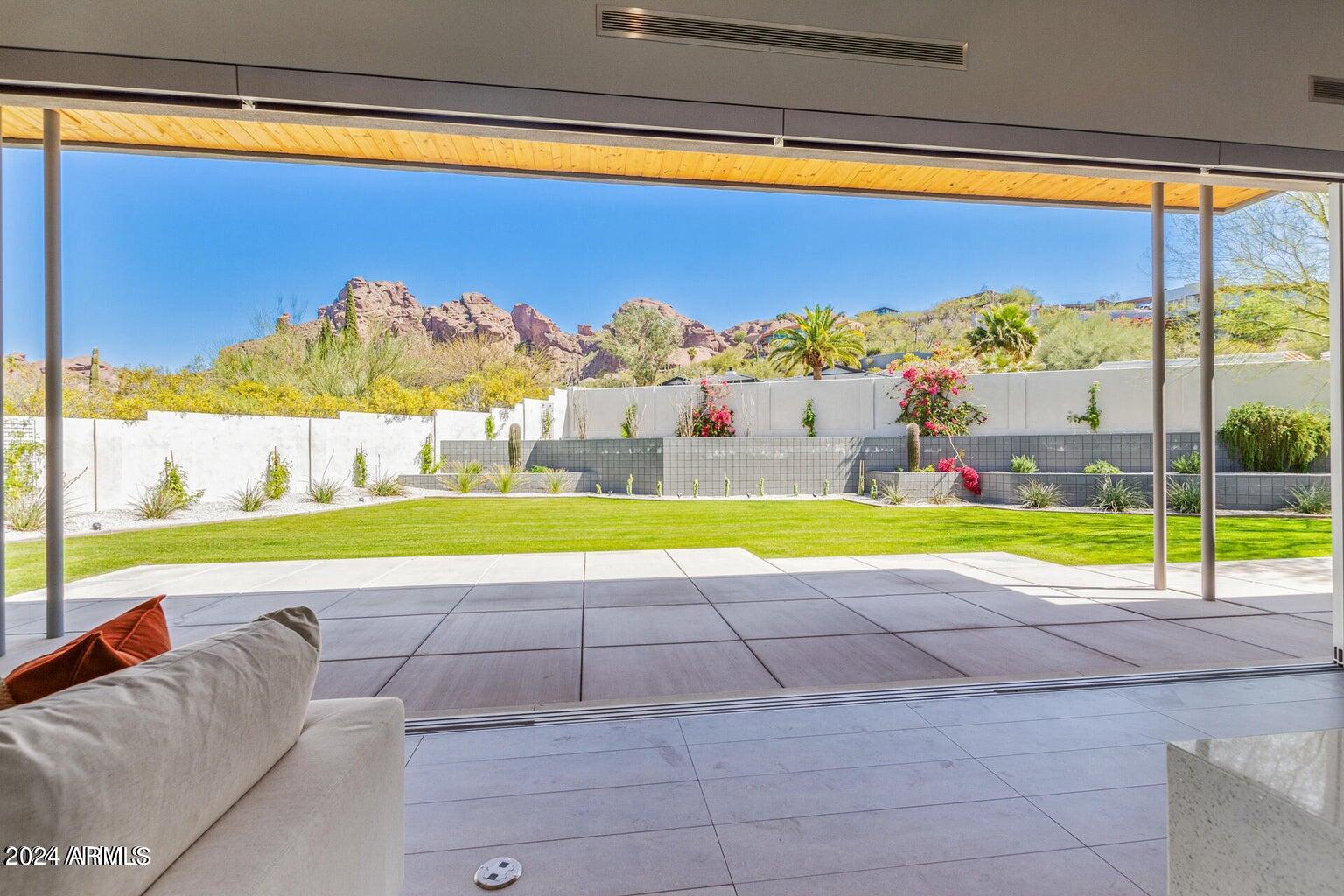 5833 North 46th Street Phoenix, AZ 85018 - Photo 23 of 29 a view of a big swimming pool with a lawn chairs under an umbrella