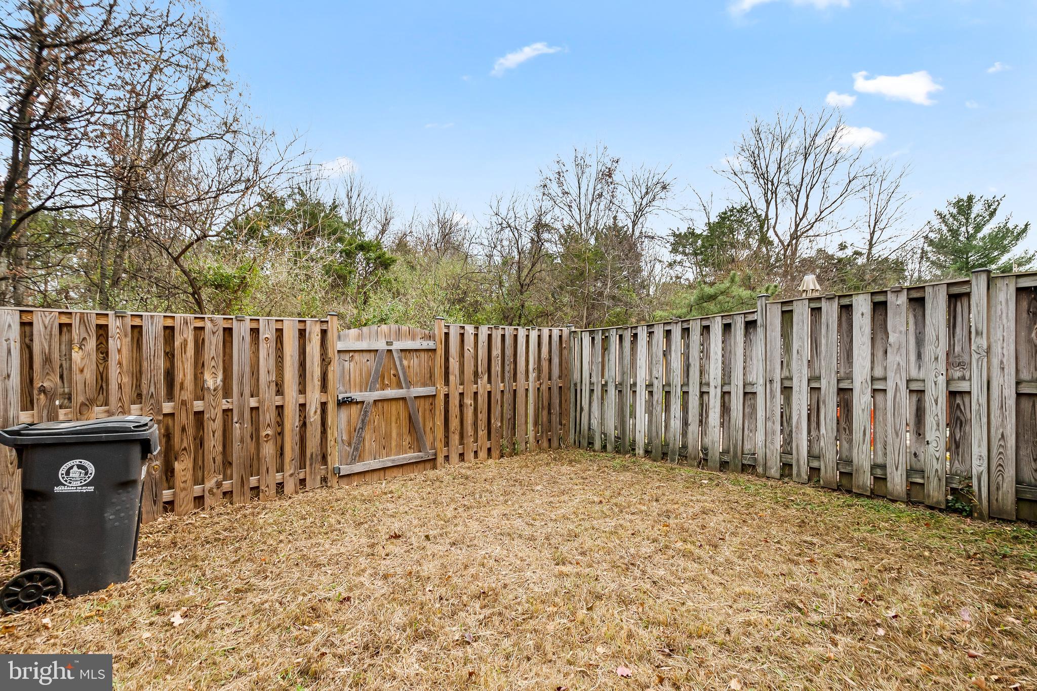 10305 Butternut Circle Manassas, VA 20110 - Photo 18 of 29 a backyard of a house with wooden fence