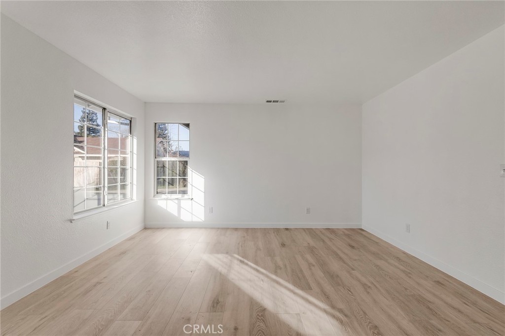 4 Cloud Court Chico, CA 95928 - Photo 11 of 46 an empty room with wooden floor and windows