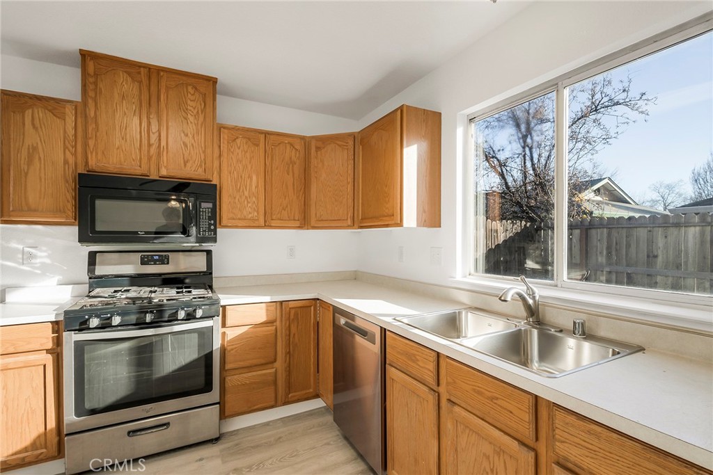 4 Cloud Court Chico, CA 95928 - Photo 17 of 46 a kitchen with a sink stove and microwave