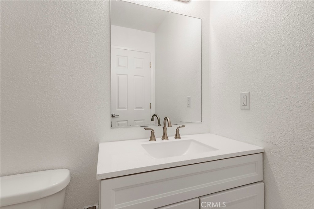 4 Cloud Court Chico, CA 95928 - Photo 22 of 46 a bathroom with a sink a toilet and mirror