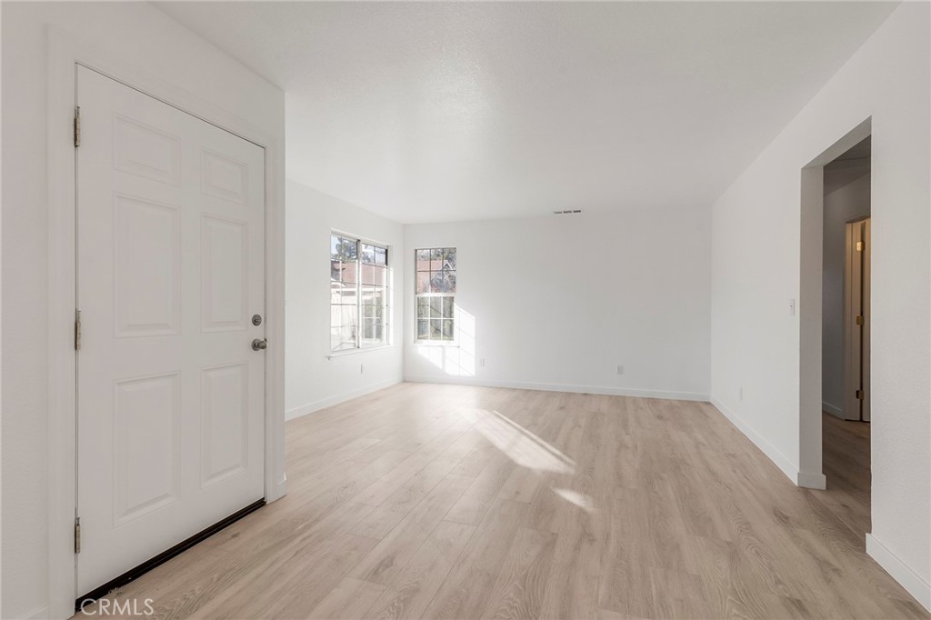 4 Cloud Court Chico, CA 95928 - Photo 9 of 46 an empty room with wooden floor and windows
