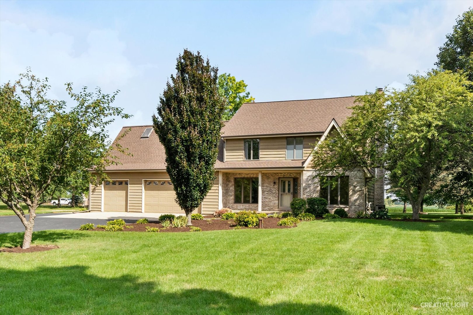 a front view of a house with a garden